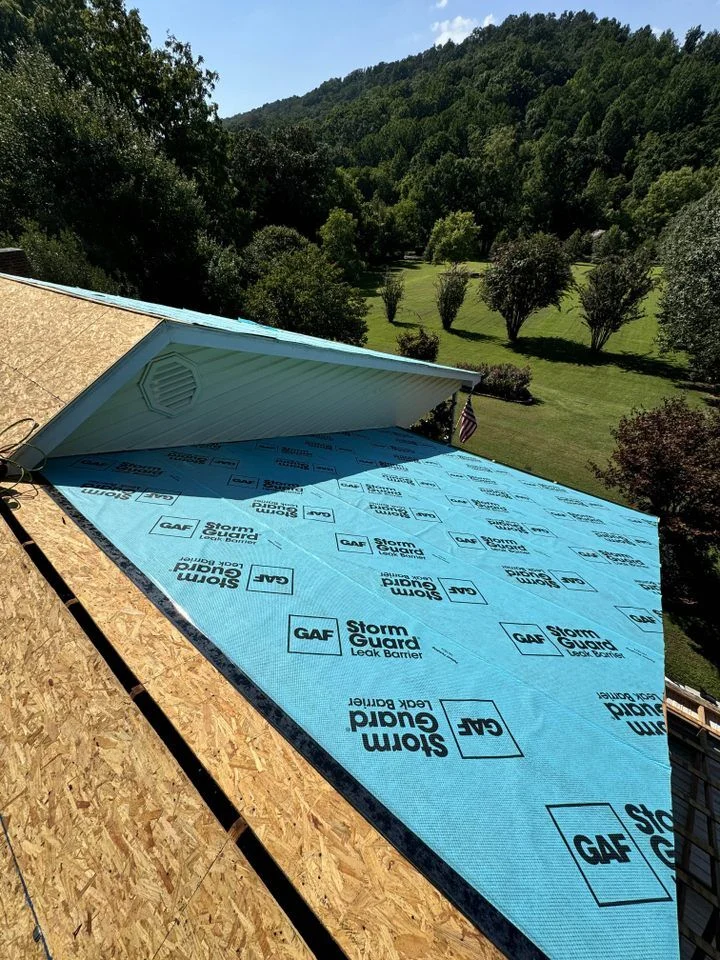 Daniel Hood Roofing installing GAF StormGuard roof underlayment before residential roof installation.