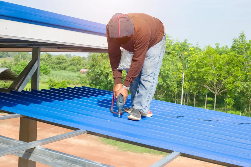 Roofer installing a metal roof