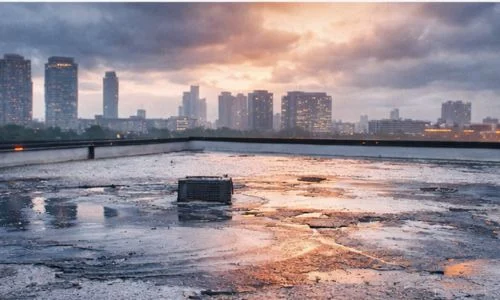 Commercial flat roof with standing water after a storm, highlighting Daniel Hood Roofing's Emergency Commercial Roof Repair services for fast leak response.