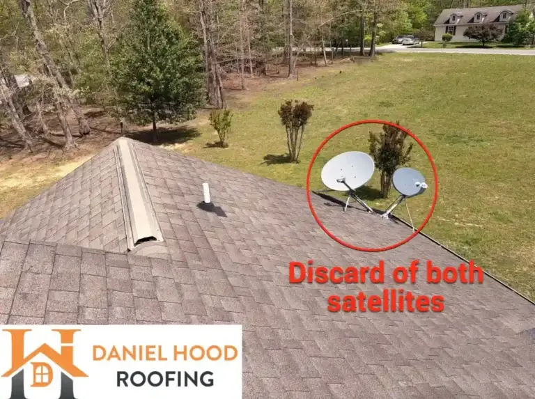 Two satellite dishes mounted on an asphalt shingle roof scheduled for removal during roof replacement in Crossville, TN.