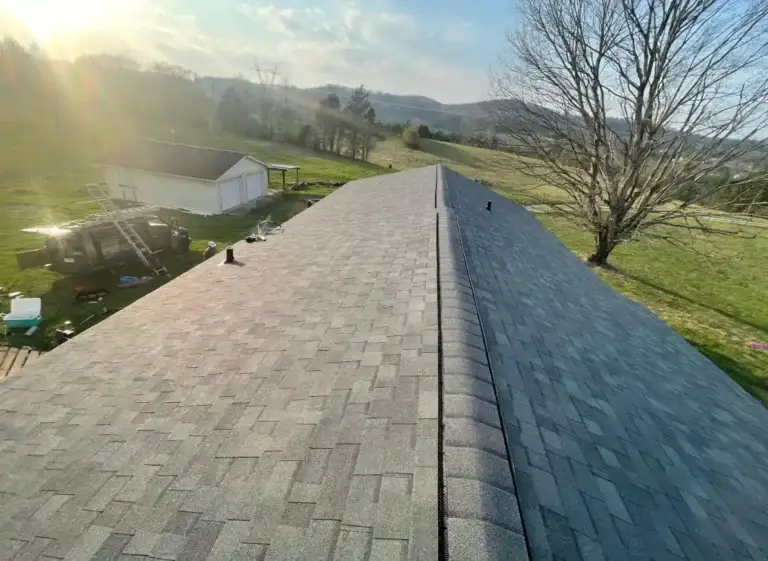 Completed roof replacement featuring architectural shingles and ridge vent system