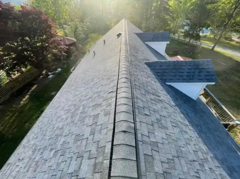 Completed roof replacement featuring architectural shingles and enhanced protection around dormers in Caryville, TN.
