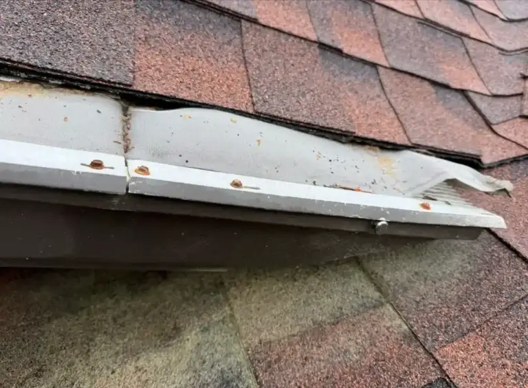 Signs of water intrusion beneath damaged gutter guard system