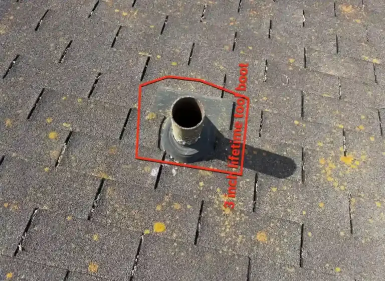 Close-up of deteriorated pipe boot identified for replacement during roofing project