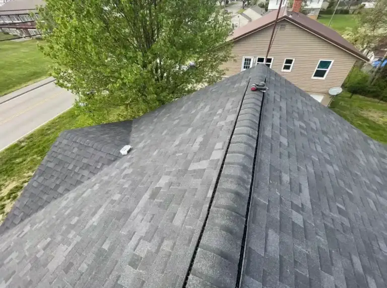 Finished roof replacement featuring architectural shingles and ridge vent system
