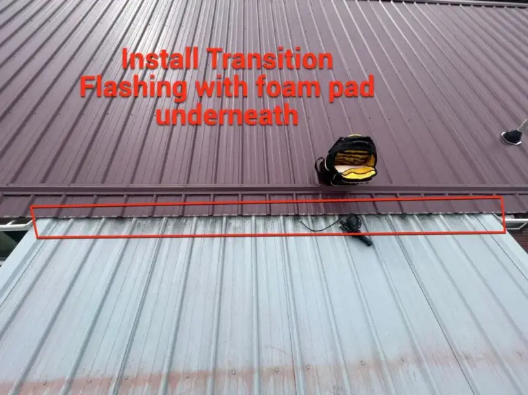 Daniel Hood Roofing Systems installing transition flashing with foam closure strips to create a watertight seal between metal roof sections.