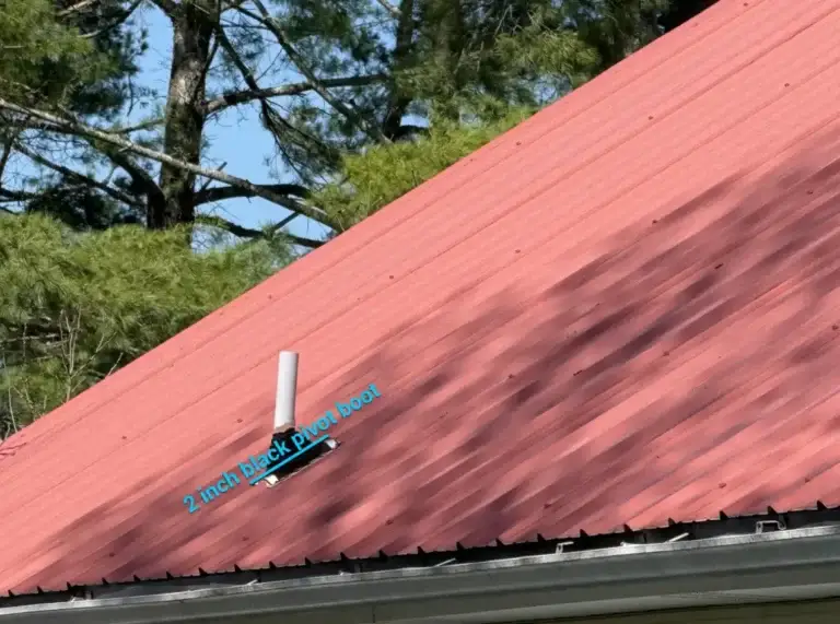 Detailed view of a metal roof pipe penetration with a 2-inch black pivot boot installed for improved leak protection.