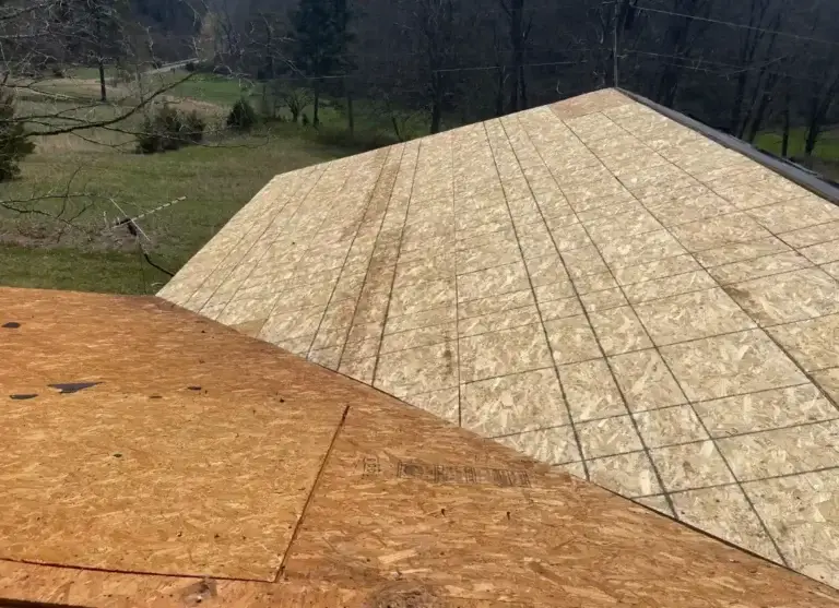 New OSB roof decking installed to replace damaged sections during roof replacement project