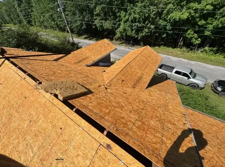 Roof replacement in progress showing new decking and multiple roof sections prepared for underlayment installation in Crossville, TN.