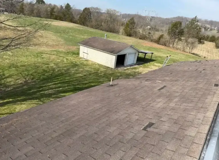 Overview of aging asphalt shingle roof prior to complete roof replacement