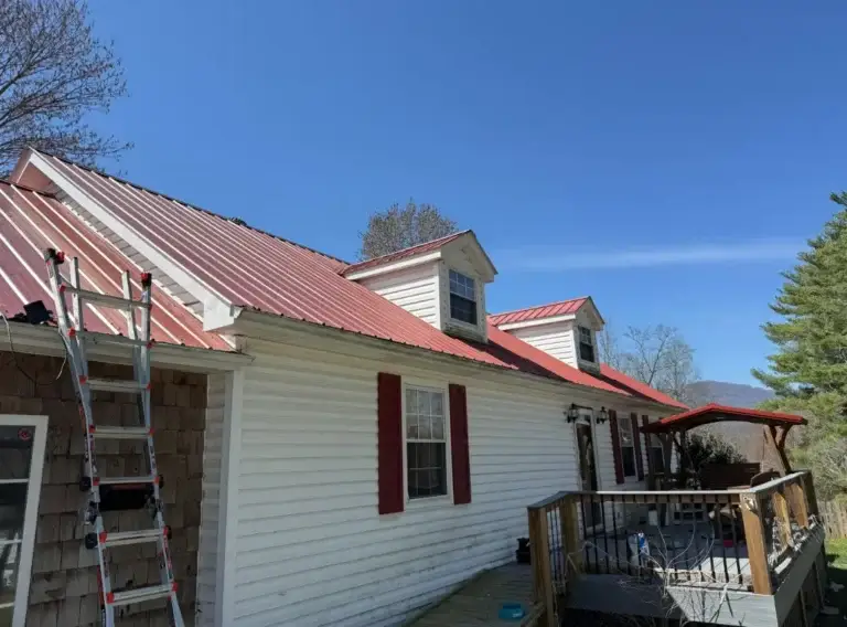 Existing red metal roof with recurring leak issues inspected by Daniel Hood Roofing Systems in Caryville, TN.