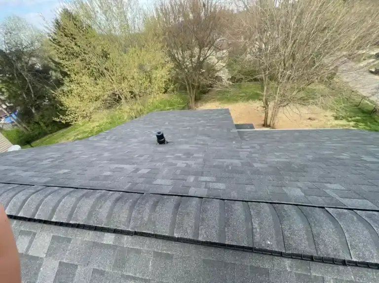 Overhead view of newly installed residential shingle roof with ridge vent