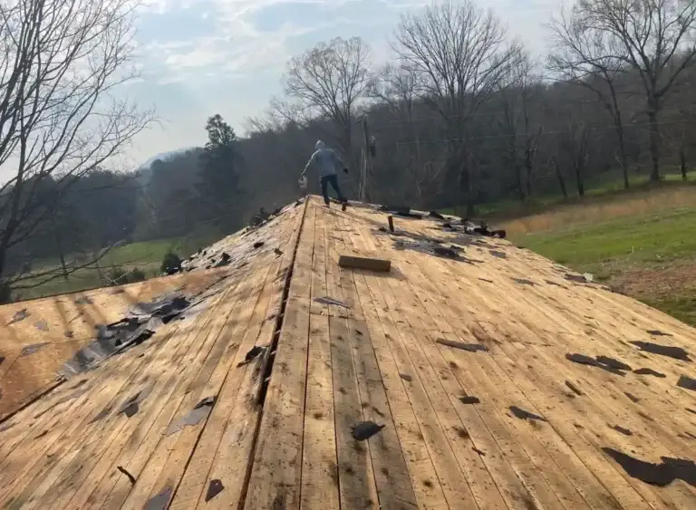 Roof tear-off process underway before installing new roofing materials and underlayment