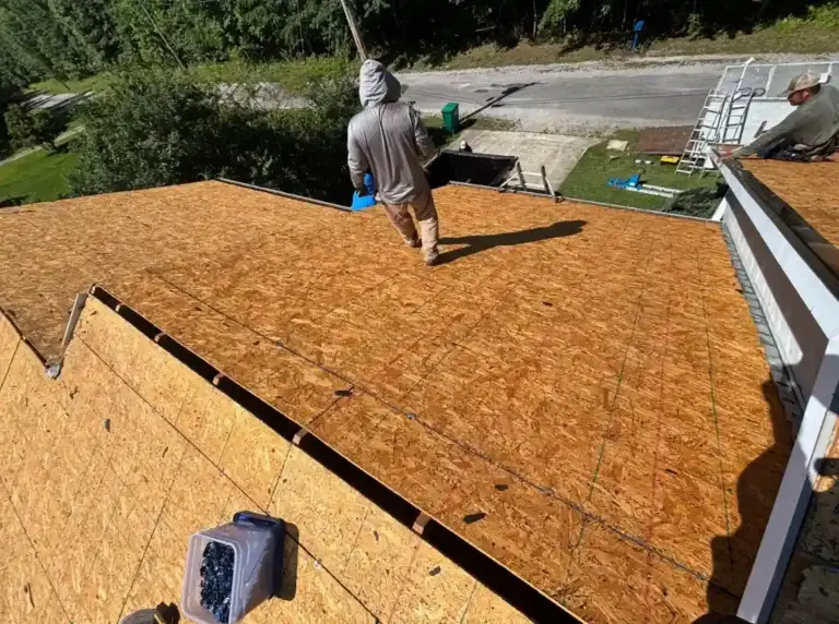 Roofing crew working on newly installed roof decking during a residential roof replacement project in Crossville, TN.