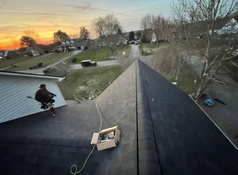Sunset view of a completed shingle roof with ridge vent installation by Daniel Hood Roofing.