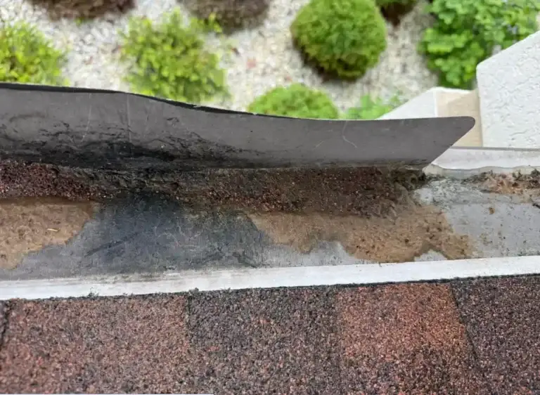 Signs of water intrusion beneath damaged gutter guard system