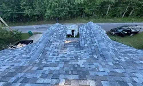 Wide view of the completed roof system featuring new architectural shingles and properly capped ridges in Crossville, TN.