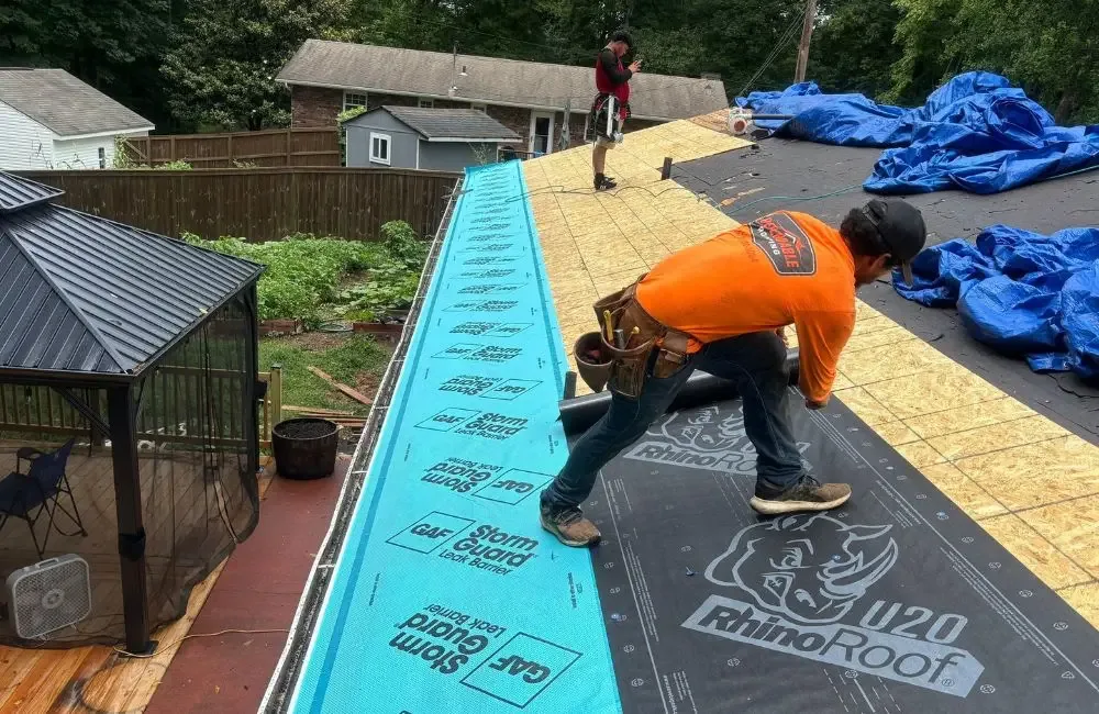 Daniel Hood Roofing crew installing synthetic underlayment and roof decking during a roof replacement